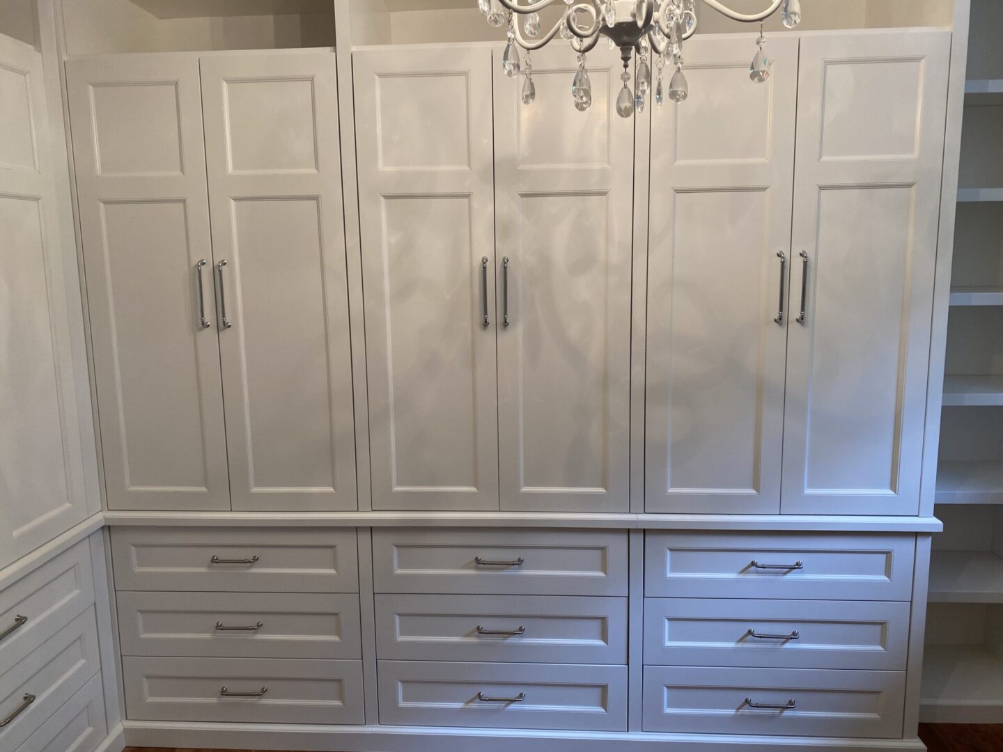 A White Color Cabinetry With Stainless Steel Handel