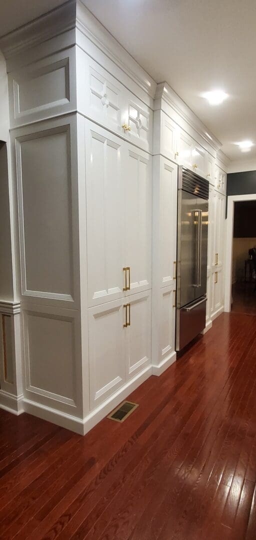A White Color Wooden Cabinets With Brass Handel