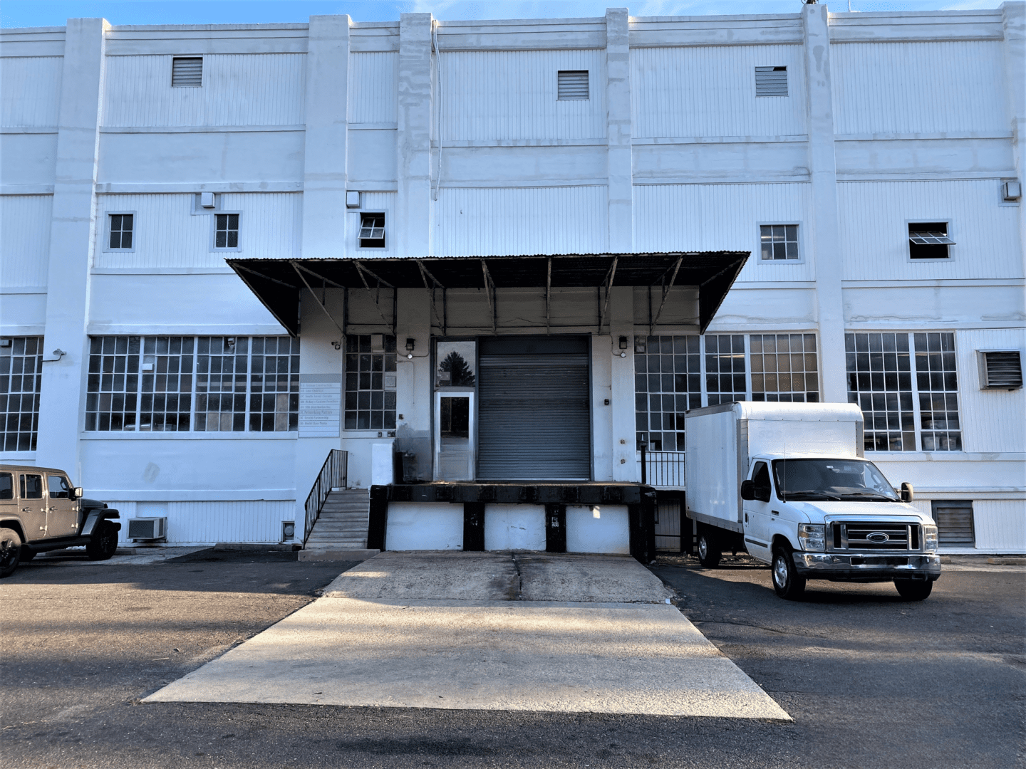 A White Color Truck Placed Outside the Building