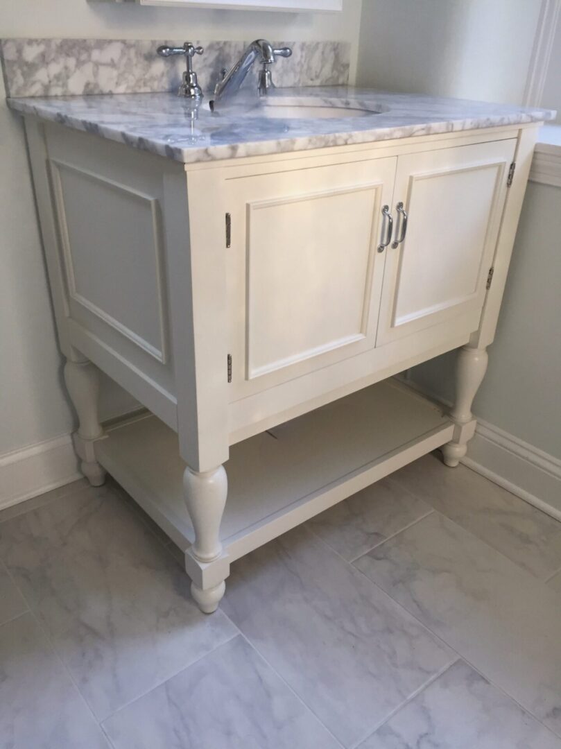A Sink Cabinet With a Marble Counter Top