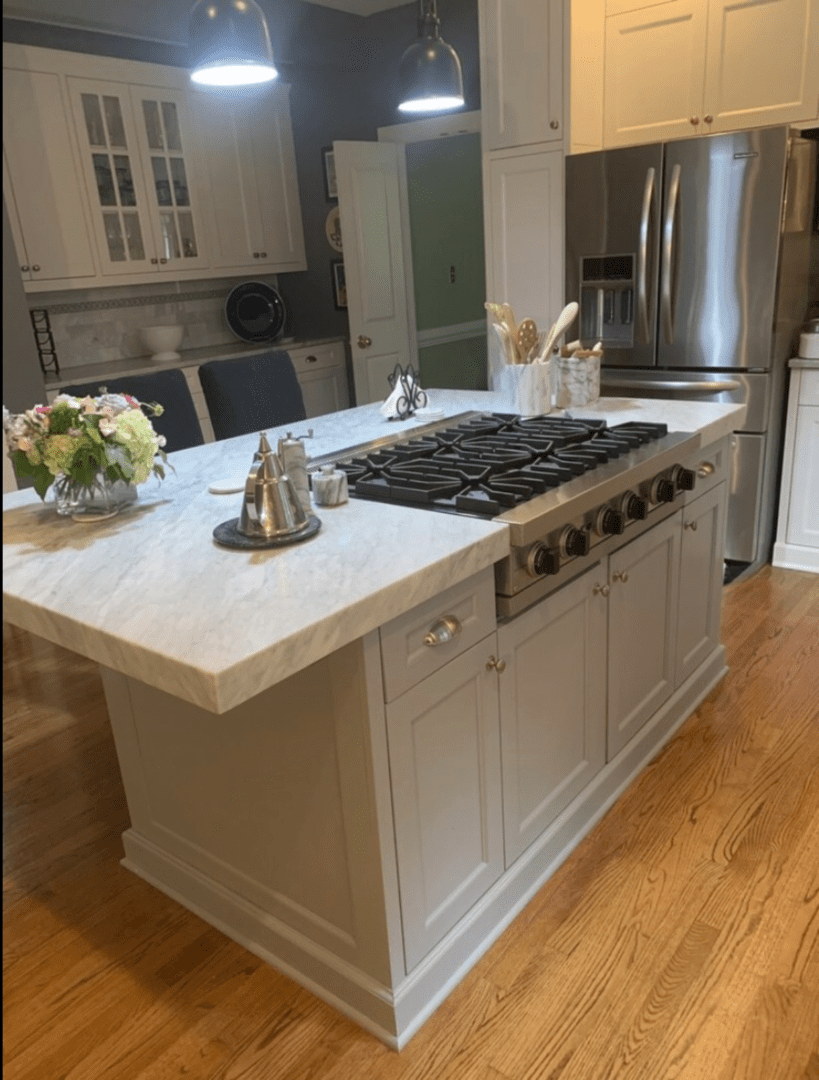 A White Color Kitchen Island With a Stove Top