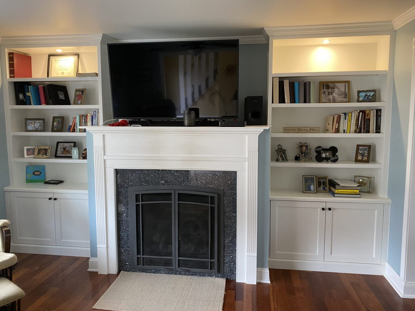 A Flat screen Above a Fireplace With Gates