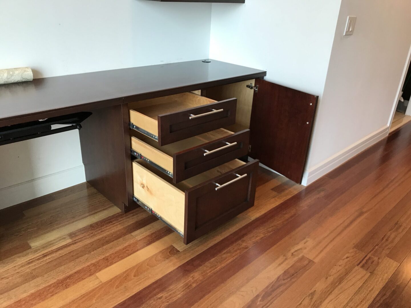 A bunch of wooden cabinets opened and wooden floor