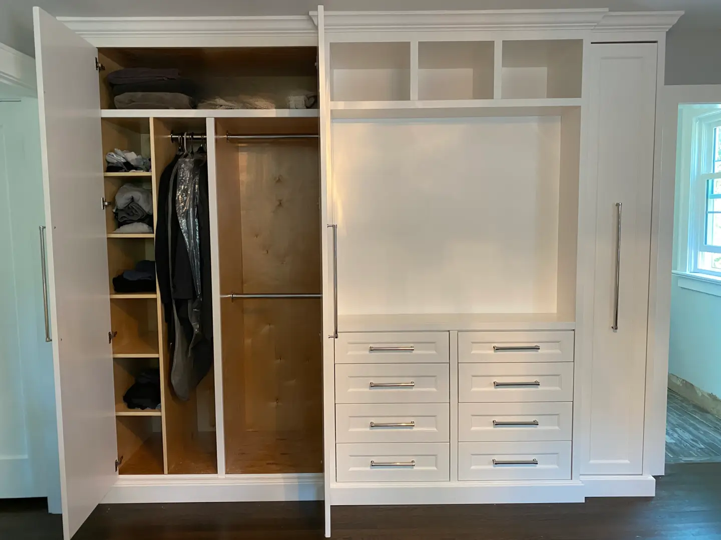 A White Color Closet Space With a Rod For Hanging