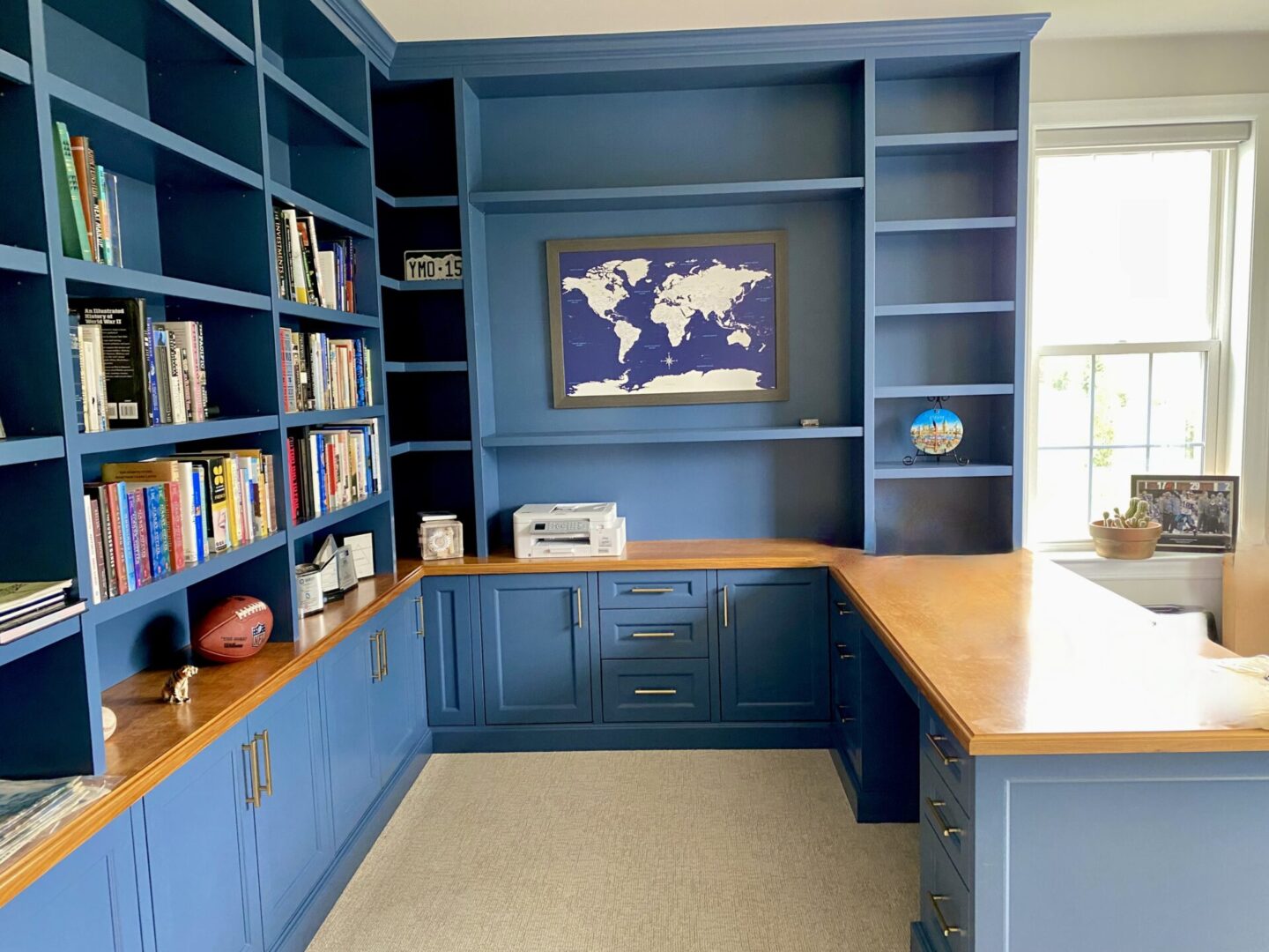 A room with blue cabinets and a world map on the wall.