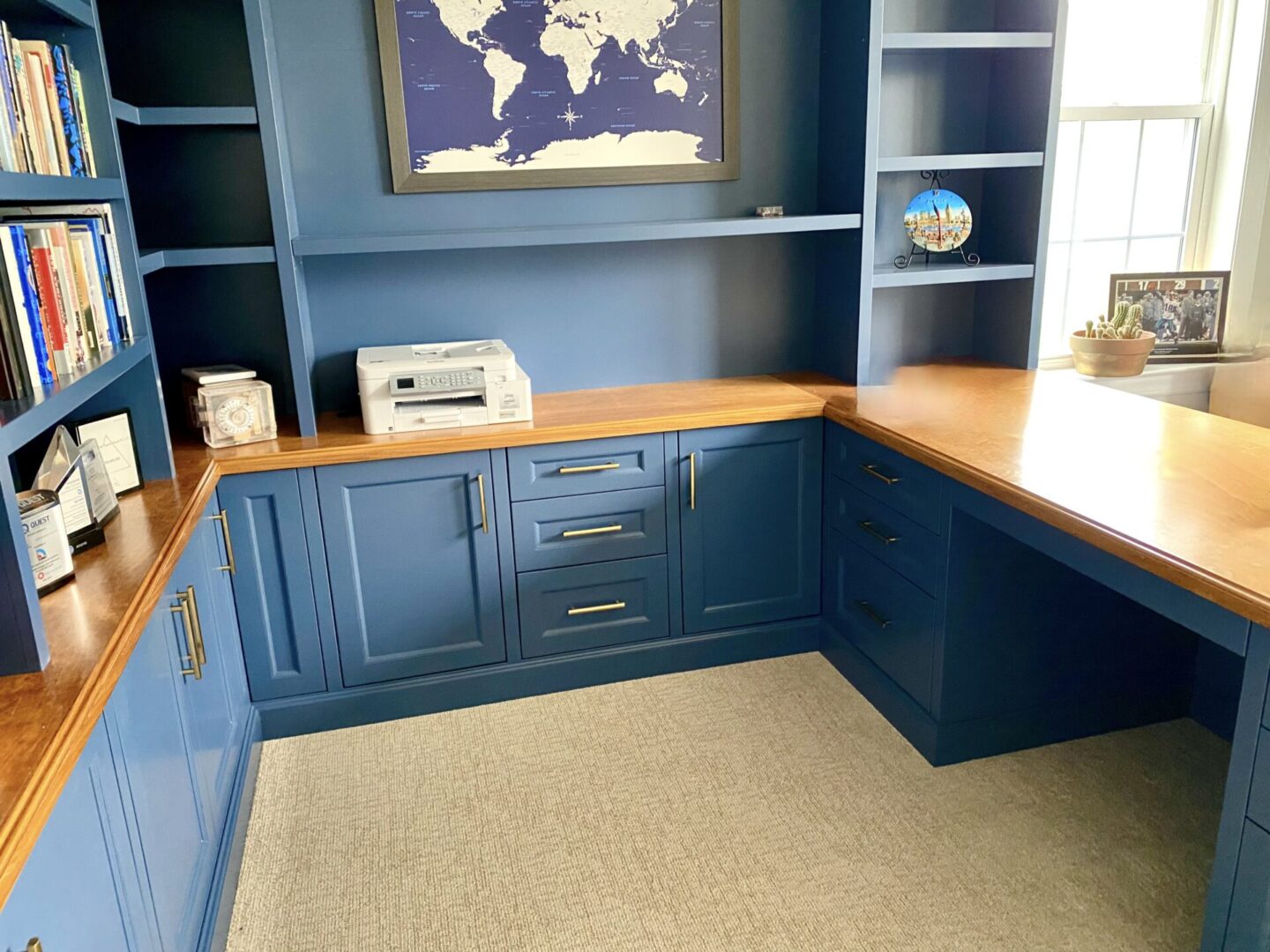 A room with blue cabinets and a world map on the wall